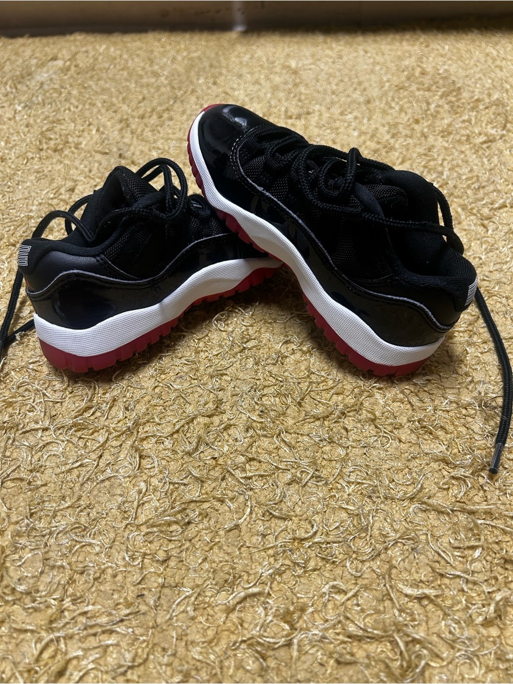 Jordan 11s black , red and white.